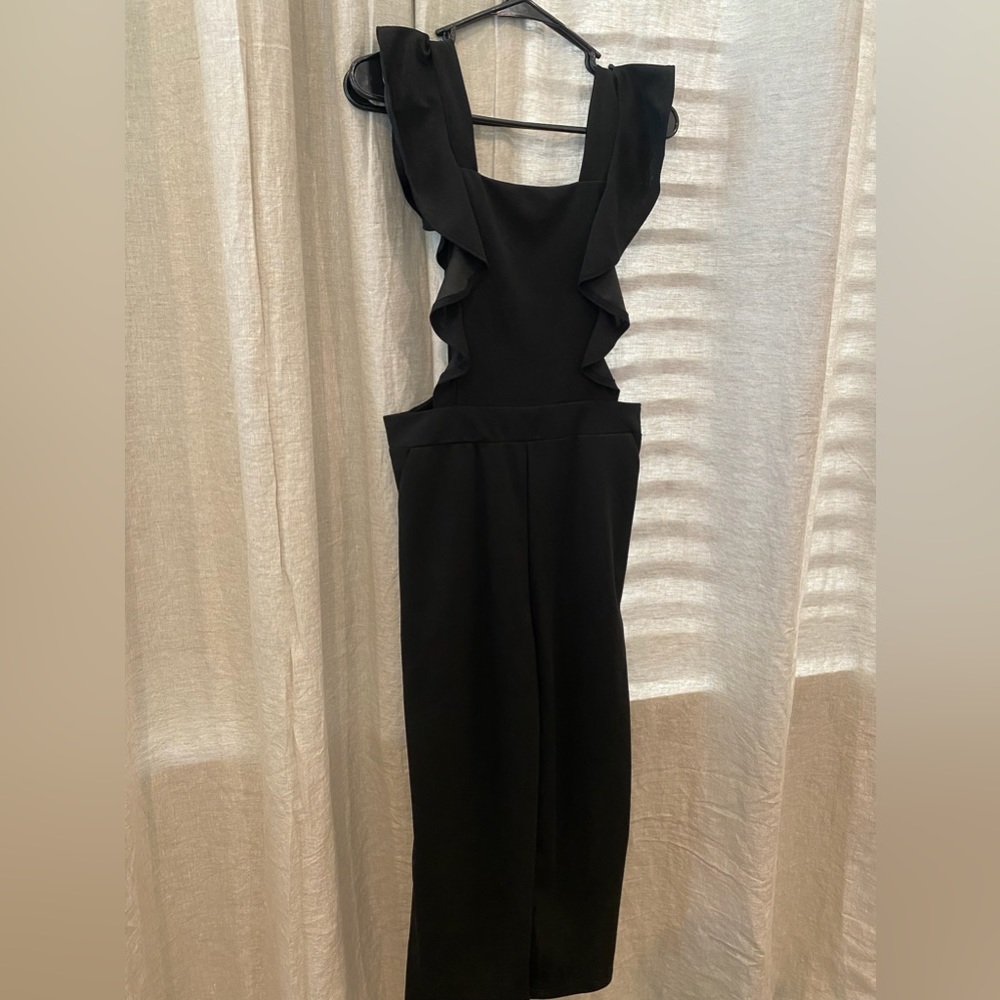 Black romper. Ruffle front. Overall style. M